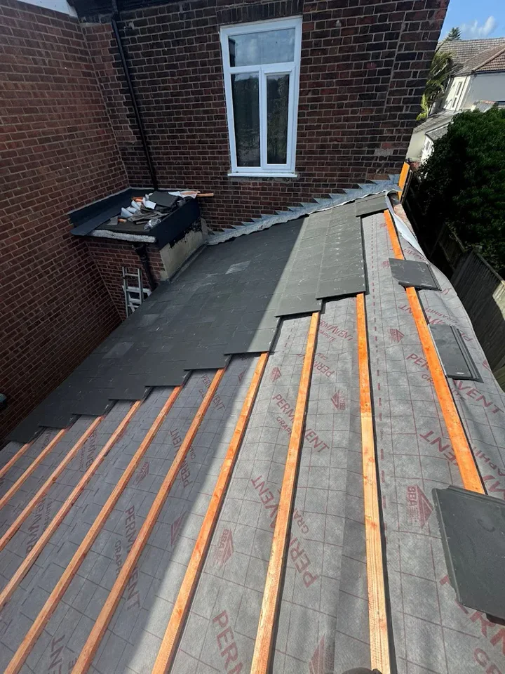 Slate installation beside a brick wall — supplied photograph
